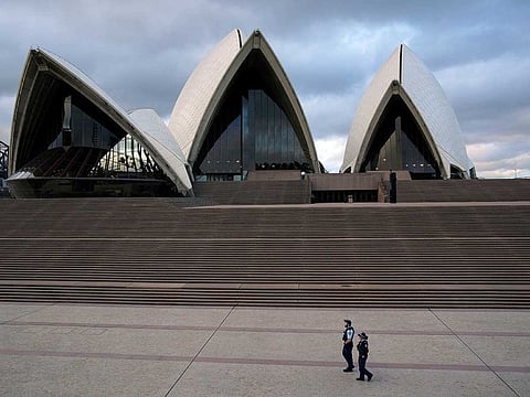 Police officers patrol near the Sydney Opera House following the implementation of stricter social-distancing and self-isolation rules to limit the spread of the coronavirus disease (COVID-19) in Sydney, Australia, April 6, 2020.
