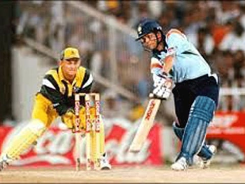 Sachin Tendulkar in full flow during his 'Desert Storm' innings in Sharjah as Adam Gilchrist looks on.