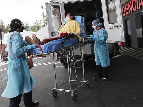 A woman suspected of suffering from COVID-19 arrives by ambulance to the Hospital del Seguro Social Quito Sur in Quito, Ecuador.