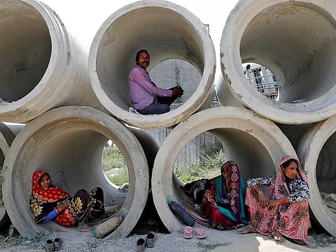 Migrant labourers rest in cement pipes during an extended nationwide lockdown to slow the spreading of coronavirus disease (COVID-19) in Lucknow, India, April 22, 2020.