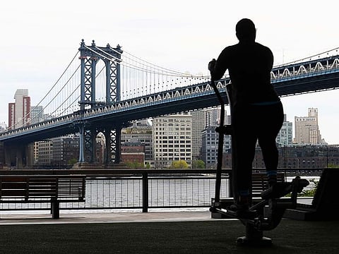A person exercises with a view of the Manhattan Bridge on April 23, 2020 in New York City, amid the novel coronavirus pandemic.