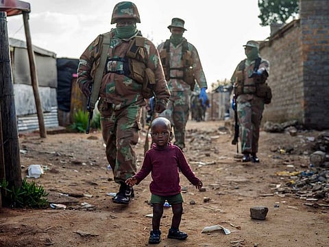 South African National Defence Forces patrol the Sjwetla informal settlement after pushing back residents into their homes, on the outskirts of the Alexandra township in Johannesburg, Monday, April 20, 2020. The residents were protesting the lack of food.