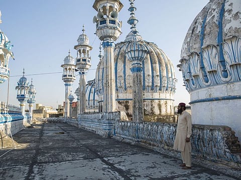 Mohammad Kazim, caretaker of the main mosque in Rawalpindi, Pakistan, on its roof on Thursday.