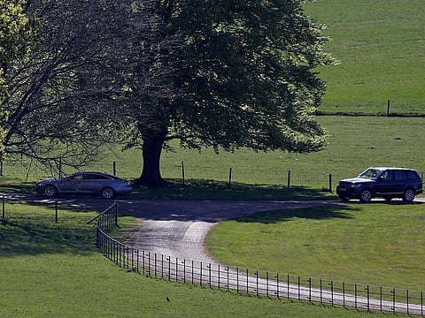 The official car (L) of Britain's Prime Minister is pictured as it leaves from Chequers, the Prime Minister's country residence, near Ellesborough, north-west of London on April 26, 2020.