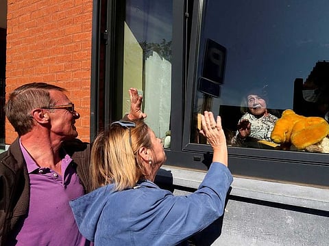 Martha Licoppe, 92, waves to her children Chantal and Christian, while sitting in her room at Belgian care home Le Cinquantenaire Orpea, amid the outbreak of the coronavirus disease (COVID-19), in Brussels, Belgium April 27, 2020.