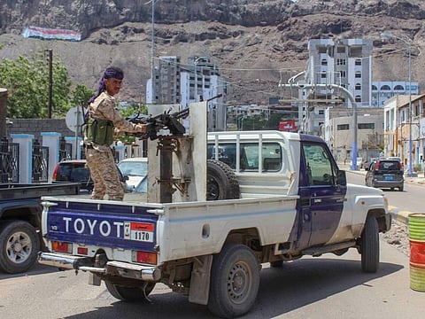 A fighter with Yemen's separatist Southern Transitional Council (STC) mans a gun in the back of a vehicle deploying in the southern city of Aden on April 26.