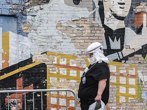 A medical worker wearing protective gear walks outside the University Hospital of Brooklyn on April 27, 2020 in the Brooklyn borough in New York City.