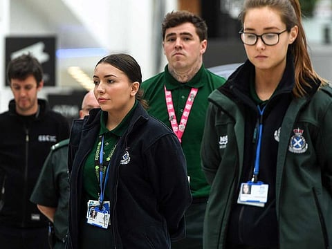 NHS staff pause for a minute's silence to honour UK key workers, including NHS staff, health and social care workers, who have died during the coronavirus outbreak at the NHS Louisa Jordan Hospital in Glasgow on April 28, 2020. Britain's health ministry on April 27 said the total toll of those having died after testing positive for COVID-19 in hospital rose to 21,092.