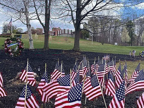 Flags and wreaths honour veterans, Tuesday, April 28, 2020, on the grounds of the Soldiers' Home in Holyoke, Mass., where a number of people died due to the coronavirus.