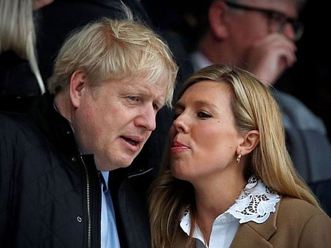 In this file photo taken on March 7, Britain's Prime Minister Boris Johnson with his fiancee Carrie Symonds attend the Six Nations international rugby union match between England and Wales at the Twickenham, west London.