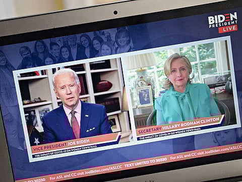 Former Vice-President Joe Biden, presumptive Democratic presidential nominee, left, speaks as Hillary Clinton, former US secretary of state, listens during a virtual event seen on a laptop computer in Arlington, Virginia, US, on Tuesday, April 28, 2020. Clinton endorsed Biden saying that she wishes he were in the White House to lead the country through the coronavirus pandemic.