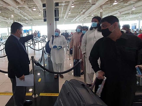 Pakistan Consul General Ahmed Amjad Ali checking passengers travelling on special flights from Dubai International Airport on Tuesday to Pakistan..