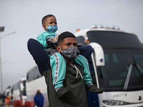 Venezuelan migrants wearing face masks participate in a protest against the blockade of buses that they hired to reach the Colombian-Venezuelan border, amid the outbreak of the coronavirus disease (COVID-19) in Bogota, Colombia April 29, 2020.