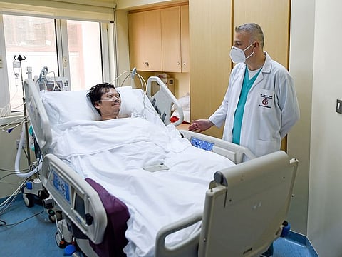 Dr Hazem Daaji with Wilfredo, a Filipino patient, at the ICU ward of Al Zahra Hospital in Sharjah.