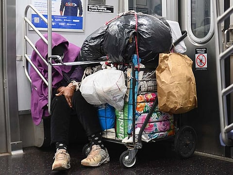 A homeless person sleeps in a subway train on April 29, 2020 in New York City.