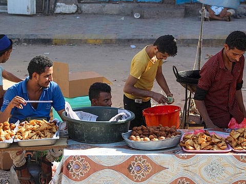 Yemeni street vendors wait for customers in the southern Yemeni city of Aden on April 27, 2020.