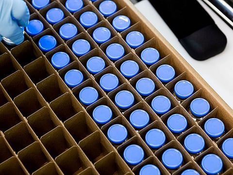 A lab technician loads bright stock filled vials of investigational coronavirus disease (COVID-19) treatment drug remdesivir at a Gilead Sciences facility in La Verne, California.