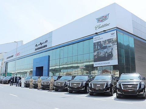 (Right to Left) Colonel Obaid Mubarak Alketbi, Major General Abdullah Ali Abdulla Ghaithi, Director, General Department of Protective Security & Emergency, Buti Saeed Mohammed Al Ghandi, Mark Jenkins, CEO of Al Ghandi Auto, Waleed Al Sayed, General Manager of Sales at Al Ghandi Auto and the 10 Cadillac Escalades donated by Al Ghandi Auto to Dubai Police to help support the Stay at Home Initiatives across the city.