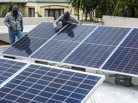 Workers install solar panels onto the roof of a residential property in Johannesburg, South Africa, on Friday, Mar. 13, 2020. The coronavirus lockdown will cause the biggest drop in energy demand in history, with only renewables managing to increase output through the crisis.
