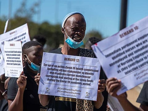 Health workers, unions & civil society hold a picket outside Chris Hani Baragwanath Hospital in Soweto, South Africa, Friday, May 1, 2020, demanding personal protective equipment (PPE) for all front line health workers. South Africa began easing one of the world's strictest lockdowns on Friday, with runners and dog-walkers returning eagerly to the streets but not all wearing the face masks that are now mandatory in the country with Africa's most coronavirus cases.
