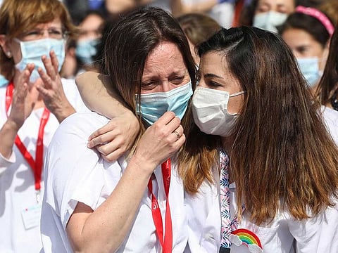 Health workers wearing protective face masks react after last patients were discharged from a temporary hospital set up at IFEMA fairgrounds, before it's closure, amid the coronavirus disease (COVID-19) outbreak in Madrid, Spain May 1, 2020.
