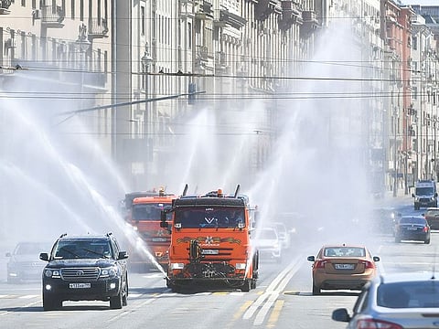 Vehicles spray disinfectant while sanitizing a road amid the outbreak of the coronavirus disease (COVID-19) in Moscow, Russia May 1, 2020.