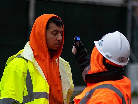 A construction worker has his temperature taken before being allowed on a job site at Manhattan's Hudson Yards development on April 24, 2020.