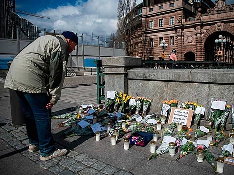 A memorial in Stockholm's Mynttorget square, on April 29, 2020, in memory of loved ones lost to the new coronavirus featuring candles, flowers and handwritten notes, some of which express frustration over Sweden's softer approach to curbing the illness.