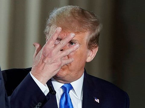 U.S. President Donald Trump gestures during a commercial break as the president participates in a live Fox News Channel virtual town hall