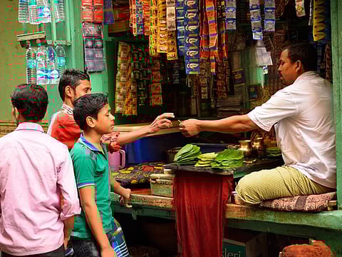 A street vendor selling paan or betel leaf in his shop in Patna.