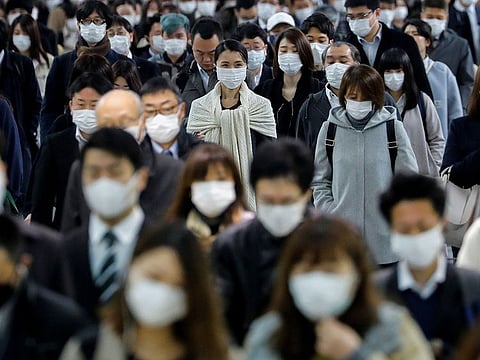 People wear face masks at Shinagawa station after the government expanded a state of emergency following the coronavirus disease (COVID-19) outbreak, in Tokyo, Japan
