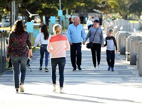 Pedestrians walk along the promenade at Balmoral Beach during a partial lockdown imposed due to the coronavirus in the Mosman suburb of Sydney, Australia, on Tuesday, May 5, 2020.