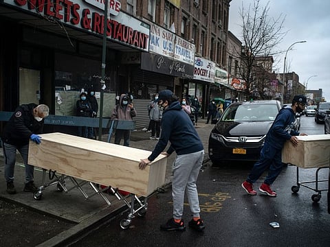 Caskets are loaded into a van outside Al Rayaan Muslim Funeral Services in Brooklyn on April 24. The number of funerals has risen to about 15 each day, compared to 20 to 30 a month before the coronavirus arrived.