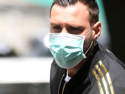 AC Milan's Antonio Donnarumma with a protective face mask as he arrives at Hospital Clinica La Madonnina for general medical tests after Italy allowed Serie A teams to start training individually as the country begins a staged end to a nationwide lockdown due to a spread of the coronavirus pandemic.