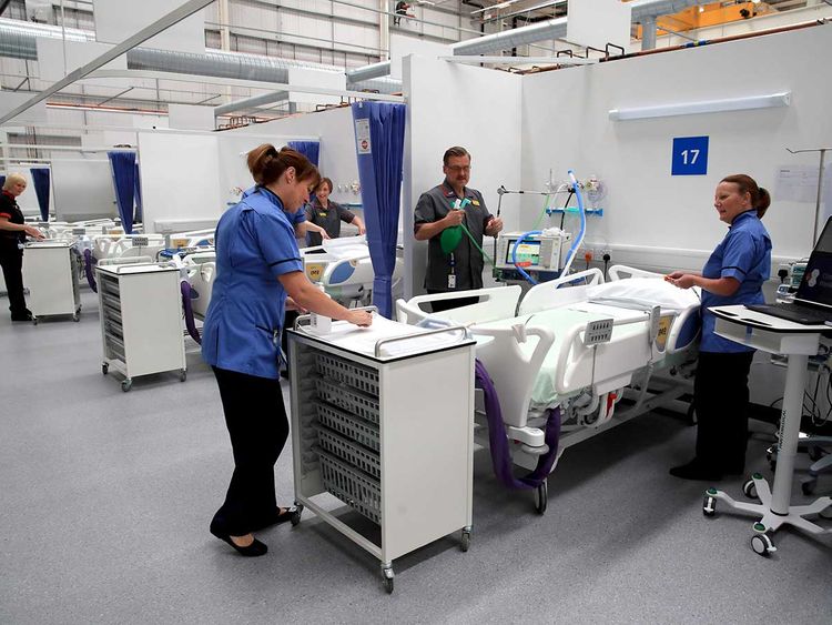 Staff prepare bays at the NHS Nightingale Hospital North East in Sunderland, northeast England on May 5, 2020 providing 460 beds for patients with coronavirus. The 460-bed Nightingale Hospital North East officially opened in the northeast city of Sunderland as part of the UK's drive to provide increased capacity to care for patients during the COVID-19 pandemic.