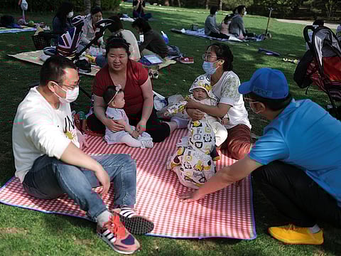 People talk while seating on picnic blankets at Sun Park during Labour Day holiday, following an outbreak of the coronavirus disease (COVID-19), in Beijing, China May 5, 2020.