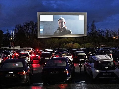Hundreds of people watch a trailer at a drive-in cinema in Essen, Germany.