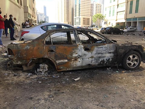 Mangled remains of cars at the base of the fire-hit tower.