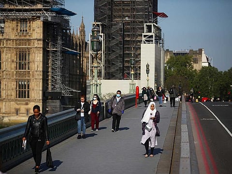 People walk across Westminster Bridge in London following the outbreak of the coronavirus disease (COVID-19), London, Britain, May 6, 2020.