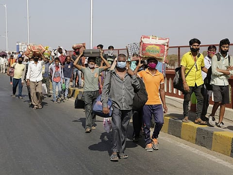 Indian migrated workers walks on a bridge in search of transportation to take them back to their home states, during a nationwide lockdown.