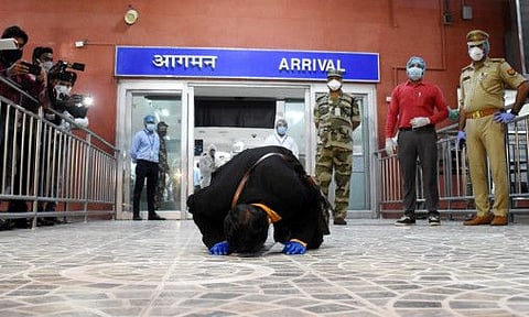 Uttar Pradesh, May 10 (ANI): Hazi Mohd. Shajid who was stranded in Sharjah, UAE, bent down as thanksgiving gesture after arriving his homeland at Chaudhary Charan Singh International Airport by a special flight in Lucknow on Saturday. (ANI Photo)