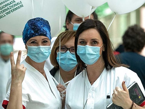 Healthcare workers react as they attend a performance by Italian violinist Fiamma Flavia Paolucci at Tor Vergata Hospital in Rome on May 12, 2020, as the world is marking International Nurses Day, during the country's partial lockdown aimed at curbing the spread of the COVID-19 infection, caused by the novel coronavirus.