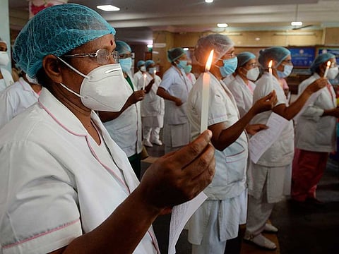 Nurses light candles at Rajiv Gandhi hospital in Kochi on May 12, 2020, as the world marks International Nurses Day, celebrated on the birthday of Florence Nightingale.