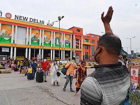 Passengers arriving by various trains, walk outside the railway station after the government eased a nationwide lockdown imposed as a preventive measure against the COVID-19 coronavirus, in New Delhi on May 13, 2020. India's enormous railway network tentatively ground back to life on May 12 as a gradual lifting of the world's biggest coronavirus lockdown gathered pace even as new cases surged.