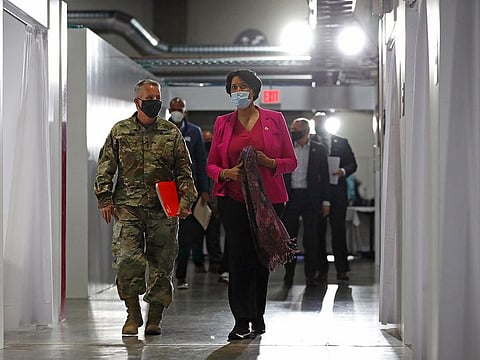 Lt. Gen. Todd Semonite, left, commanding general of the U.S. Army Corps of Engineers, departs a news conference with District of Columbia Mayor Muriel Bowser at a temporary alternate care site constructed in response to the coronavirus outbreak inside the Walter E. Washington Convention Center in Washington, Monday, May 11, 2020.