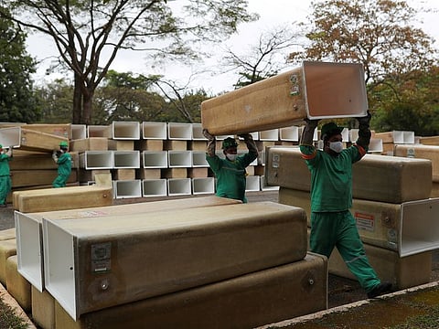 Men carry boxes to be installed for the coffins at the Sao Pedro municipal cemetery, amid the coronavirus disease (COVID-19) outbreak, in Sao Paulo, Brazil, May 14, 2020.