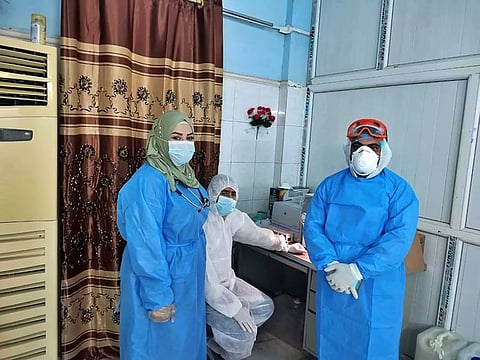 Dr. Marwa al-Khafaji, left, work at the hospital in Karbala, Iraq.