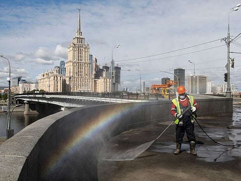 A specialist sprays disinfectant while sanitising a bridge amid the outbreak of COVID-19 in Moscow, Russia May 16.