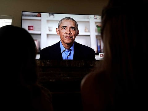 Torrey Pines High School graduating student Phoebe Seip, 18 (right), and her sister Sydney, 22, watch former United States President Barack Obama deliver a virtual commencement address to millions of high school seniors who will miss graduation ceremonies due to the coronavirus disease (COVID-19) outbreak, while celebrating Phoebe's canceled prom night at home in San Diego, California, US.