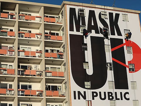 A billboard is installed on an apartment building encouraging people to wear face masks in Cape Town, South Africa, Saturday, May 16, 2020.